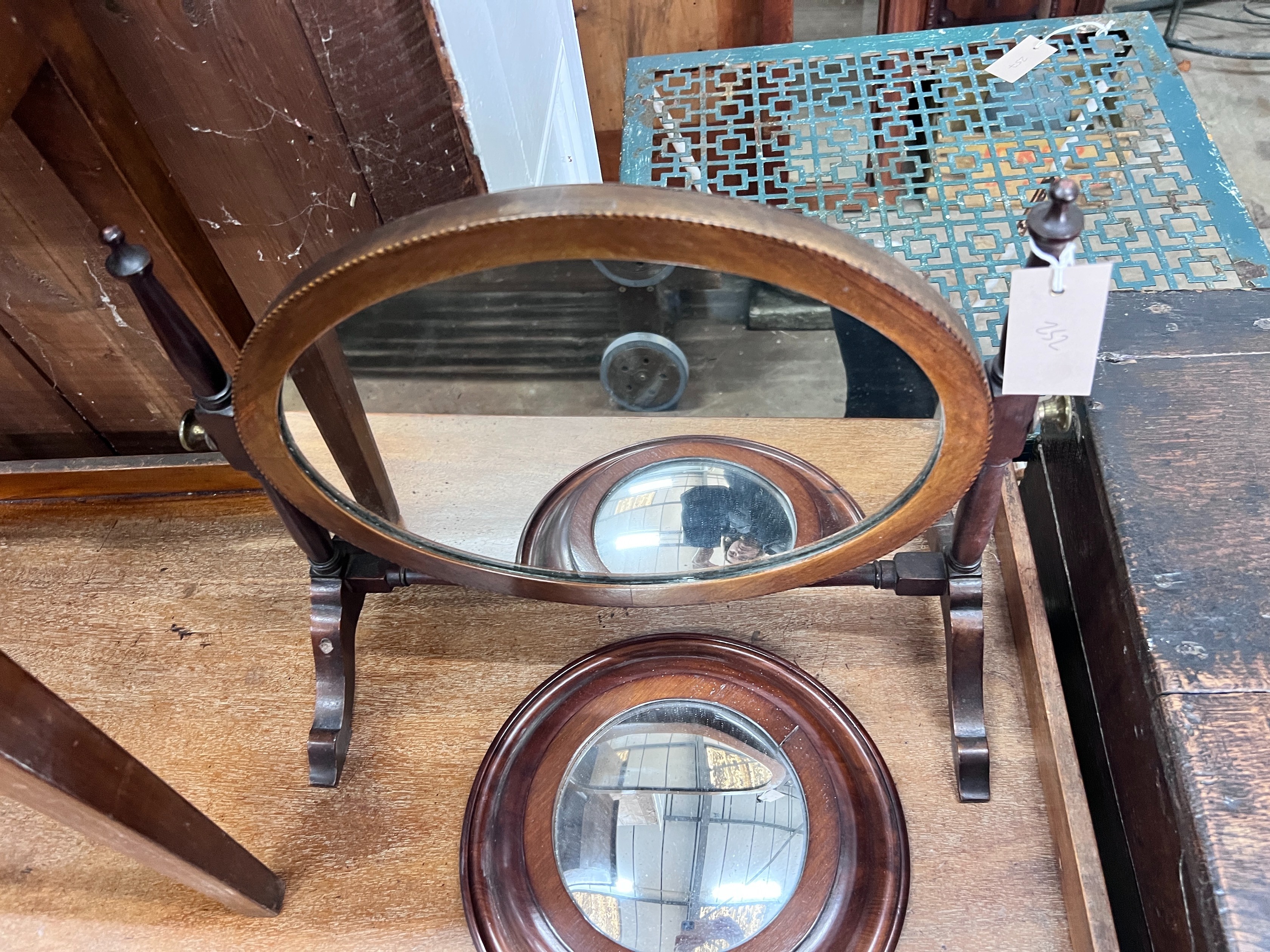 An Edwardian skeleton toilet mirror, 44cm, and a convex wall mirror, 26cm *Please note the sale commences at 9am.